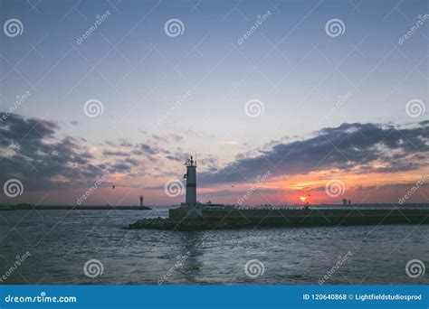 Lighthouse in Sea during Sunset Stock Photo - Image of sunset, tourism ...