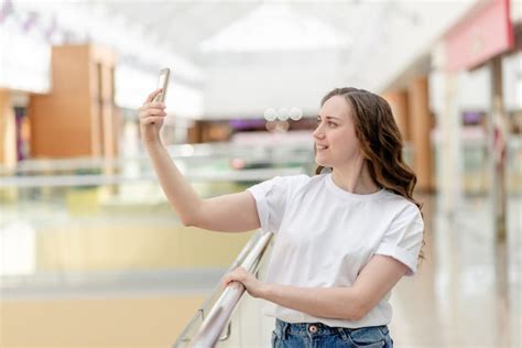 Premium Photo | Young woman with phone in her hand making selfie. portrait, happy smile, beauty ...