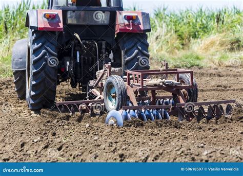 A Tractor Working Planting Wheat in the Fertile Farm Fields of G Stock ...