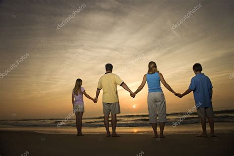 Family holding hands on beach — Stock Photo © iofoto #9498353