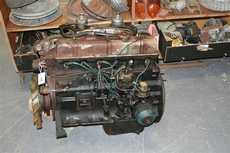 A Triumph 2500 engine. A Triumph dashboard and a large collection of miscellaneous parts and auto