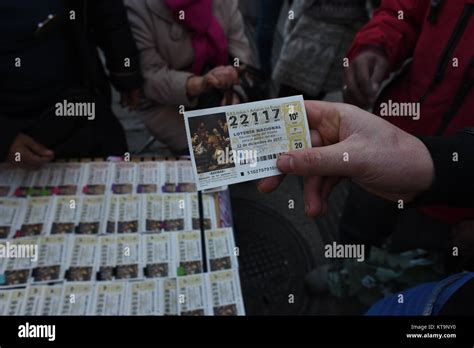 A man shows his ticket of 'El Gordo' Christmas lottery in Madrid ...