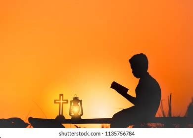 Boy Reading Bible Sunset Background Christian Stock Photo (Edit Now) 1135756784