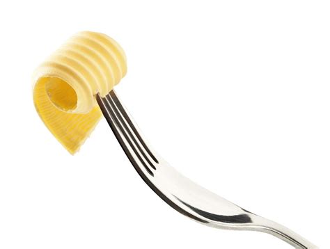 Butter curl on a fork isolated on white 2926411 Stock Photo at Vecteezy