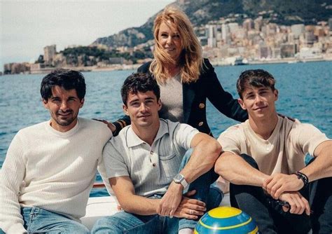 three men and a woman are sitting on a boat