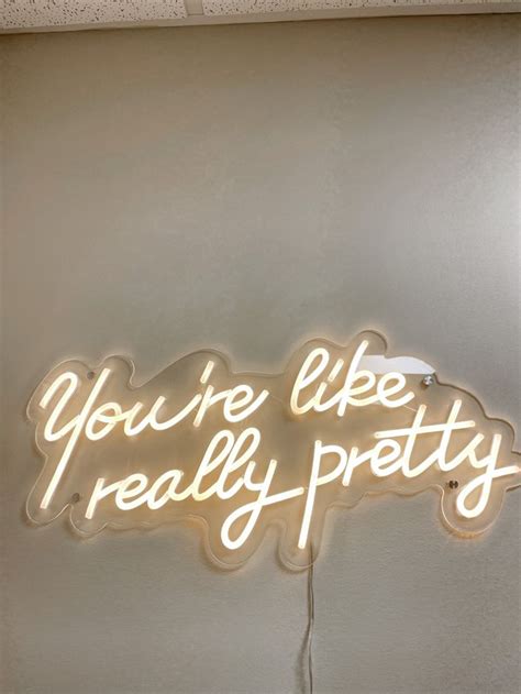 a neon sign that says you're like really pretty on the side of a wall