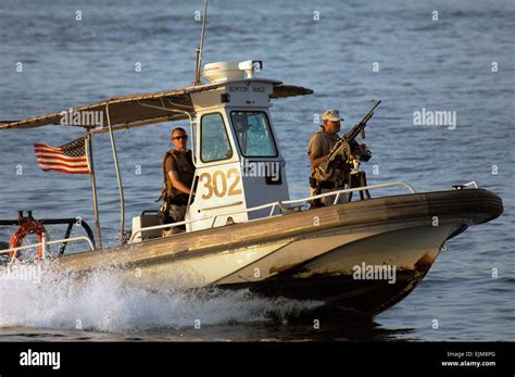 A US Navy harbor patrol boat unit from Naval Security Force Bahrain accelerates during a patrol ...