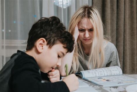 Premium Photo | Mom and son are doing homework sister helps brother solve math home schooling ...