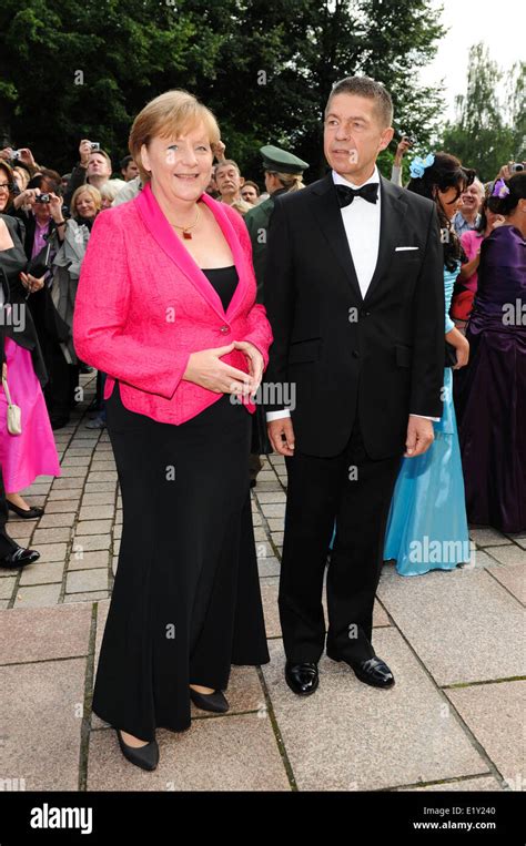 German chancellor Angela Merkel and her husband Joachim Sauer arrive ...