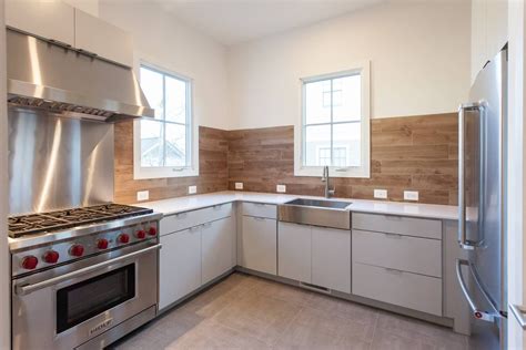 Modern kitchen with matte white slab cabinets in custom contemporary home by BCN Homes in ...