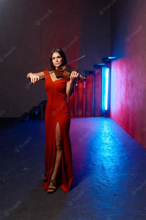 Premium Photo | Attractive woman violinist. female violin player performing solo over loft ...