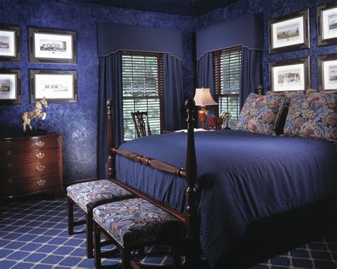 Royal-blue walls make this bedroom feel grand and spacious. Custom curtains dressed with ...