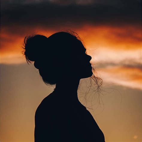 Download "A beautiful girl standing in the light and shadow of a sunset ...