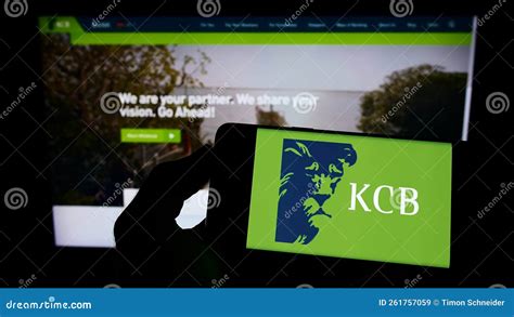 Person Holding Mobile Phone with Logo of Kenyan Financial Company KCB ...