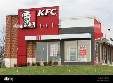 A logo sign outside of a KFC (Kentucky Fried Chicken) fast food restaurant location in Ellicott ...