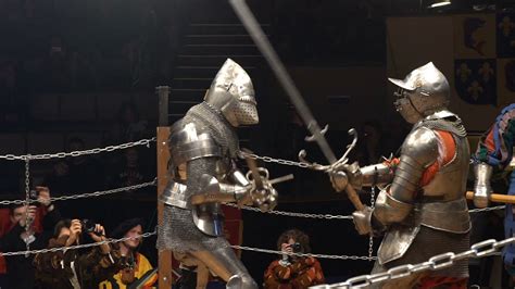 Two medieval knight fighting in the arena with two-handed swords. Slow motion. Great Knights ...