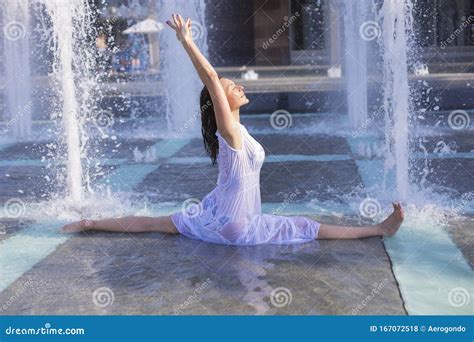 Young Woman Doing Monkey Yoga Pose in City Fountain Stock Photo - Image of exercise, stretch ...