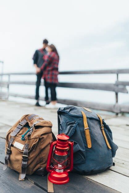 Premium Photo | Hiking backpacks with a couple in the background