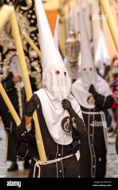 Hooded penitent looks contemplative during Semana Santa Processions Cadiz City Spain Stock Photo ...