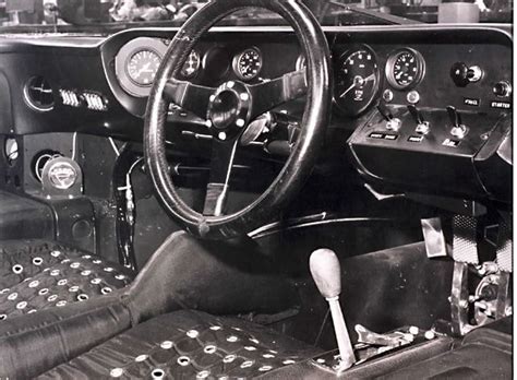 the interior of an old car with steering wheel and dashboard