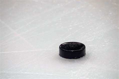 Closeup Of Hockey Puck On Ice Rink Stock Photo - Download Image Now ...