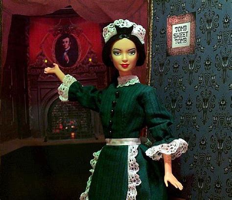 the doll is wearing a green dress with white trim