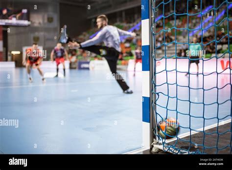 Detail of handball goal post with net and ball carrying to the goal ...