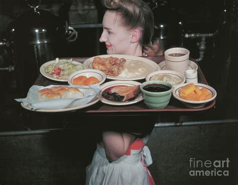 Waitress Carrying Tray Of Food Photograph by Bettmann