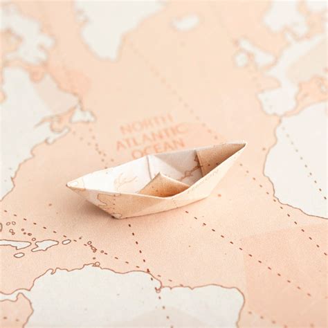 Free Photo | High angle small origami boat on map