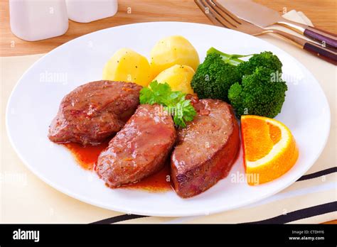 Lamb's liver or lamb fry, cooked in a sauce made from wine and orange, served with new potatoes ...