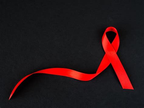 Premium Photo | World aids day concept. red ribbon on black background.