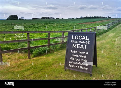 FREE RANGE MEAT LOCAL BRITISH PRODUCE Sign outside rural Cotswolds farm shop promoting local ...