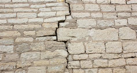 Premium Photo | Crack in a brick wall cracked stone wall