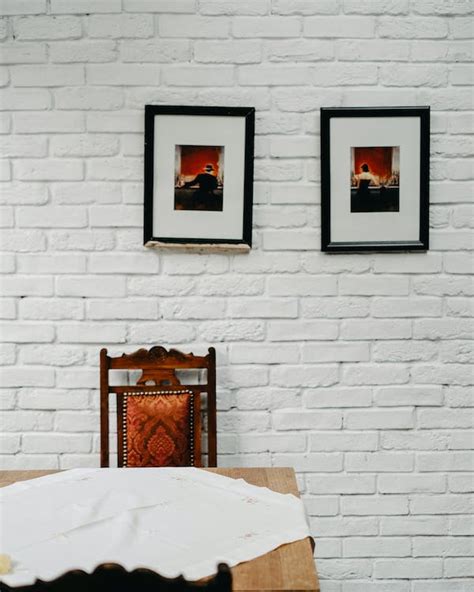 Picture Frames on a White Brick Wall · Free Stock Photo
