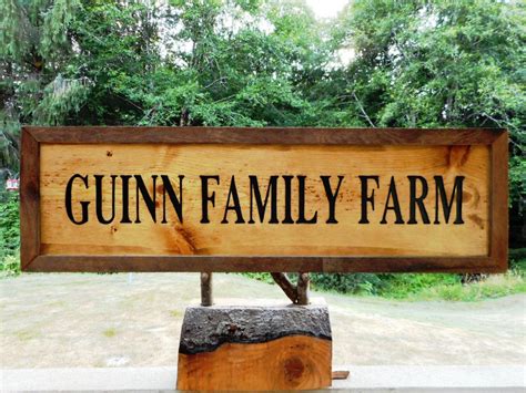 Family farm name sign with a barn beam frame. Hand-carved