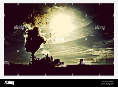 Silhouette Of Factory At Sunset Stock Photo - Alamy