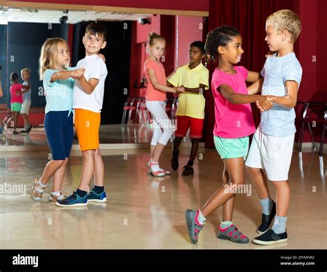 Smiling kids primary school trying dancing of partner dance in modern ...