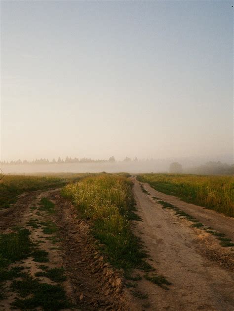 Brown Dirt Road Between Green Grass Field · Free Stock Photo