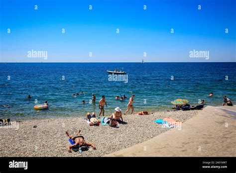 Piran, Istria, Slovenia - Beach life on the Fornace beach of the Mediterranean port of Piran ...