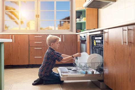 Kid Unloading Dishwasher Stock Photos, Pictures & Royalty-Free Images - iStock