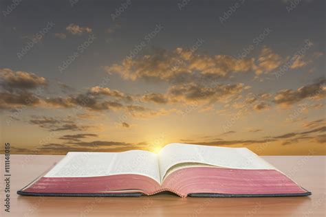 open bible with sunset sky background Stock Photo | Adobe Stock