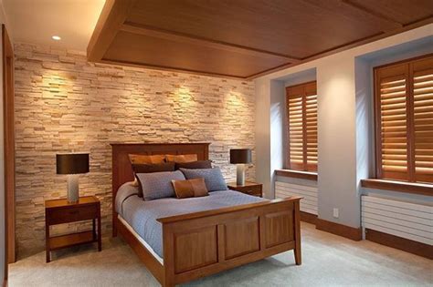 A warm wood drop ceiling and a stone accent wall gave these home owners a warm and welcoming bed ...