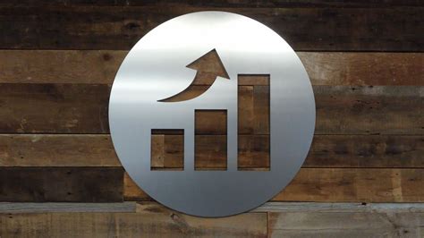 Brushed aluminum sign on a reclaimed wood wall gives this tech company a hip yet inviting vibe ...