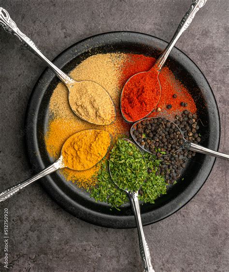 Assorted of colorful spices (red pepper powder, turmeric powder, black pepper, dried parsley ...