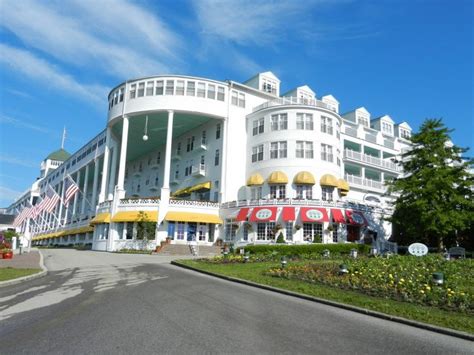 a large white building with red and yellow awnings on the top of it