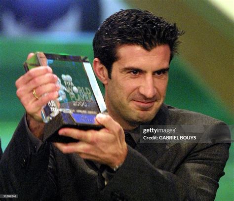 Portuguese Real Madrid striker Luis Figo holds his trophy of FIFA's ...