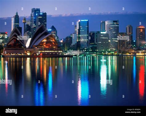 Bright night lights reflecting off Sydney skyline with Opera House ...