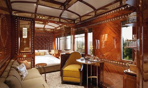 the interior of a train car that is decorated in wood and glass with gold accents