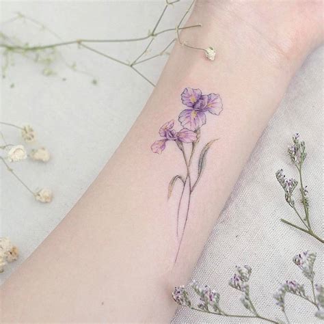 Iris flower tattoo on the inner forearm.