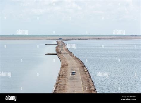 View of the straight road through submerged white desert during monsoon ...